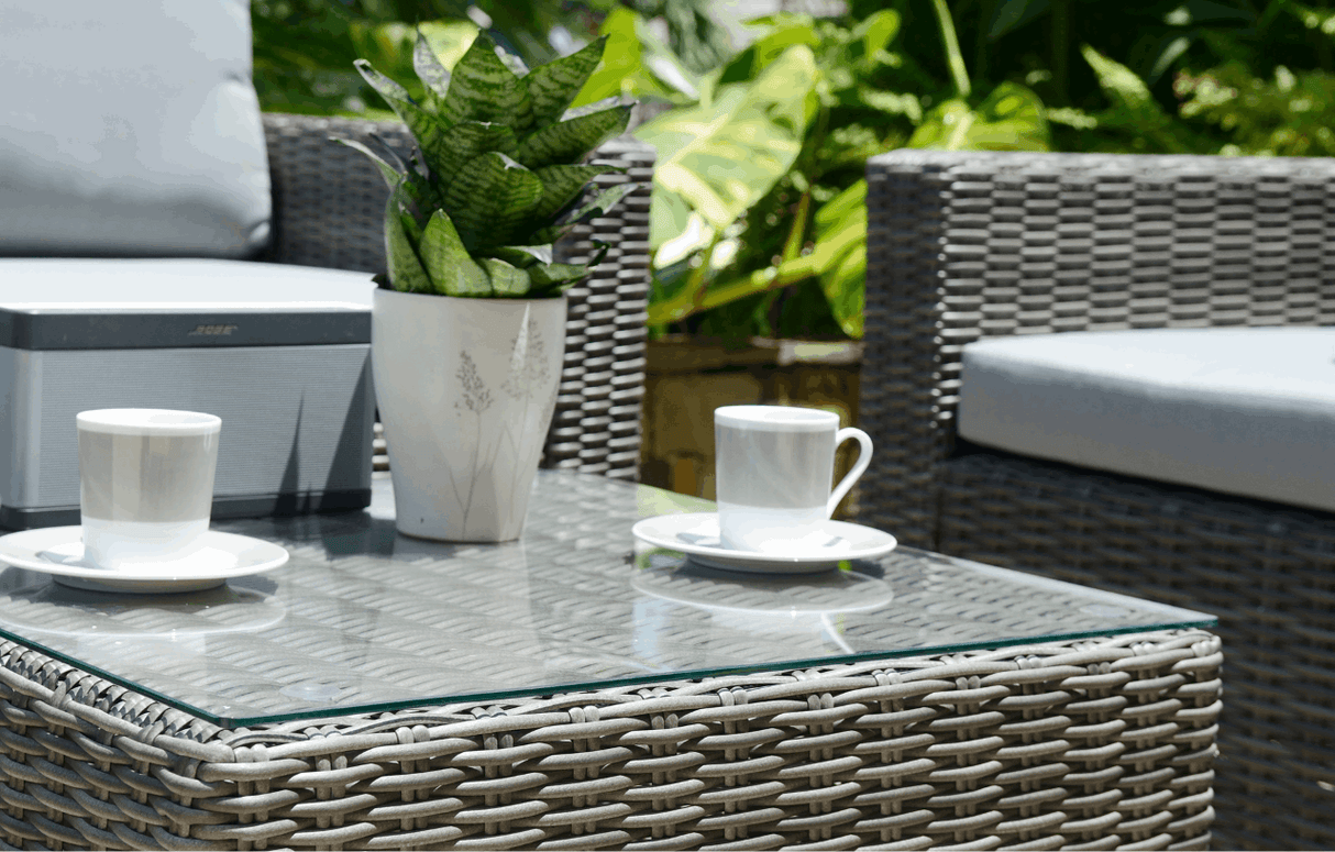 MINT Outdoor Garden Sofa Set with grey cushions and glass-top coffee table featuring potted plant
