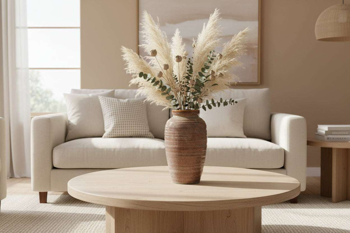 Amphora Vase on a wooden coffee table with dried flowers, enhancing a modern living room decor