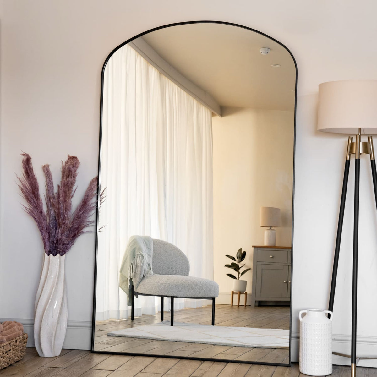 Jobu Home Arch Mirror with Black Frame in Bright Room Featuring Natural Light