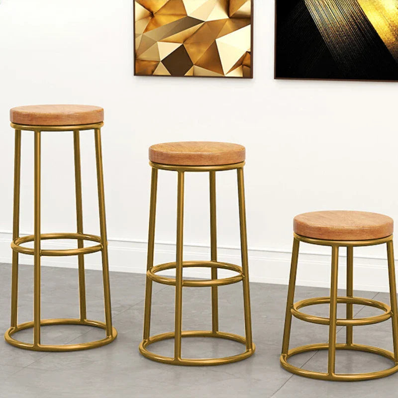 Set of three Nisu Home bar stools with gold frames and tan upholstered seats for stylish seating