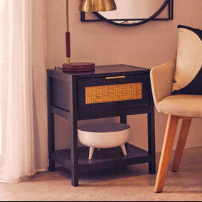 Orsina Bedside Table in black with rattan drawer and lower shelf, stylishly accentuating any bedroom decor