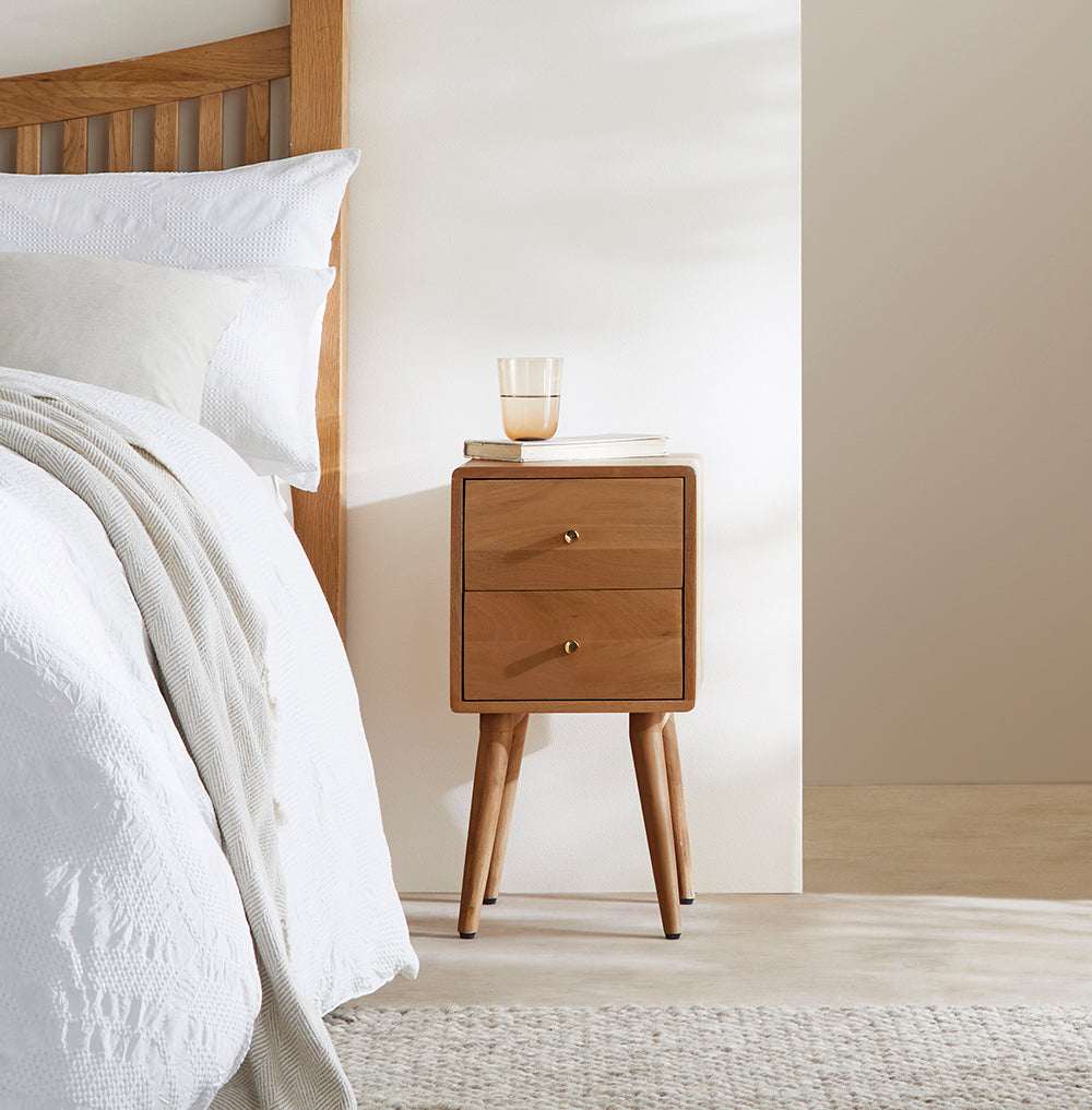 Fishe and Lilly stylish bedside table with two drawers, placed beside a bed in a modern bedroom