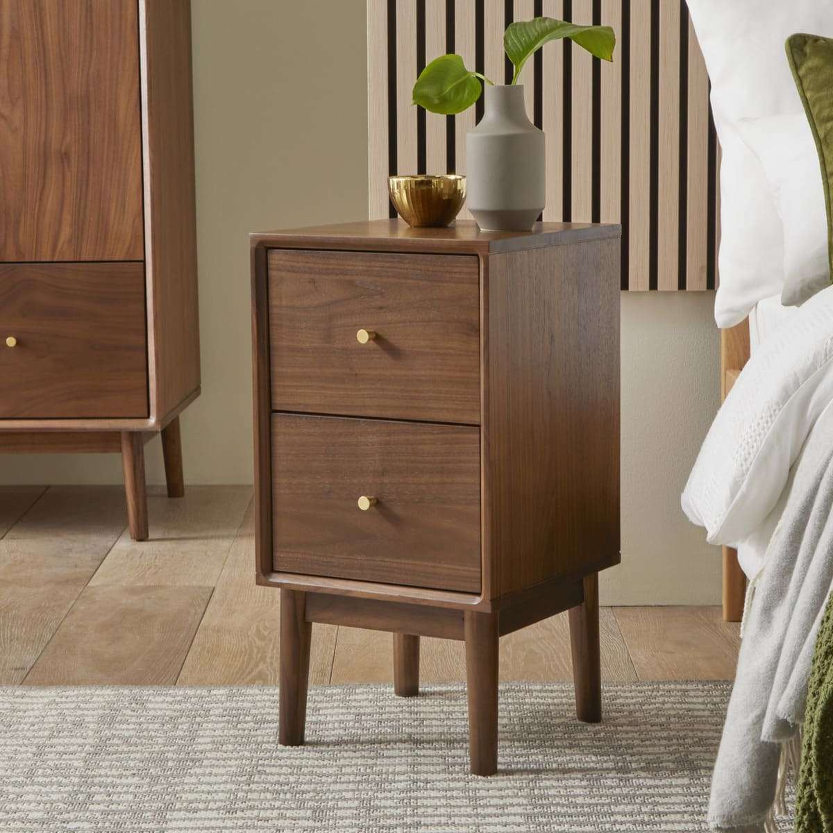 Fishe and Lilly wooden bedside table with two drawers and gold knob accents in a modern bedroom setting