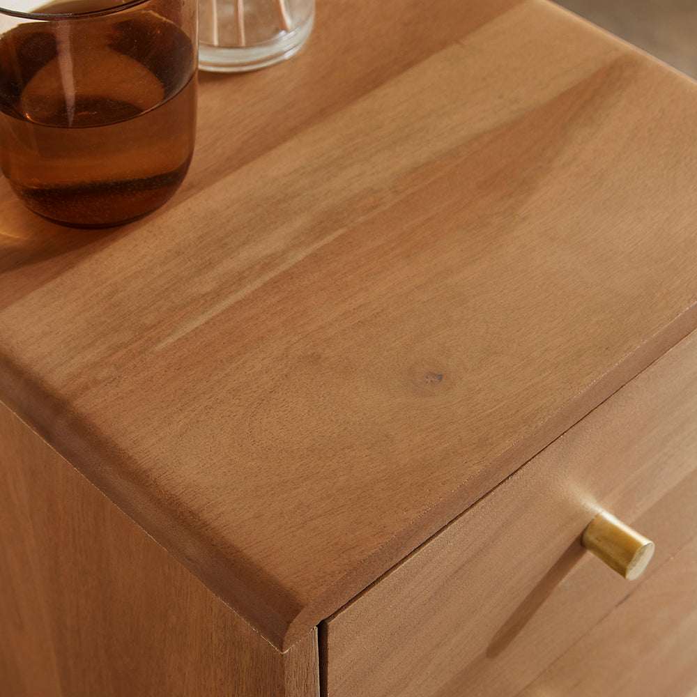 Fishe and Lilly Bedside Table in natural wood finish featuring a sleek design and a glass of water on top