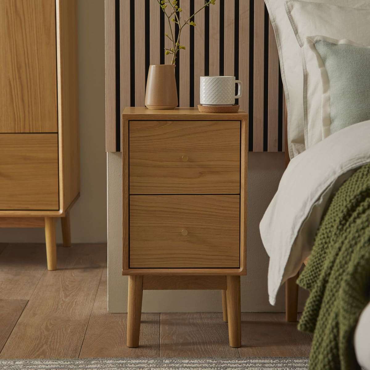 Fishe and Lilly Bedside Table in oak finish with two drawers and decorative vase
