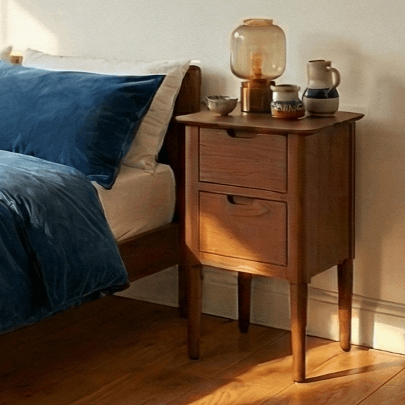 Fishe and Lilly wooden bedside table with two drawers beside a bed featuring blue bedding