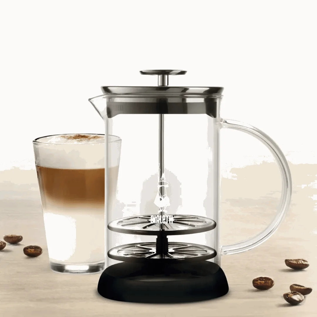 Bialetti Milk Frother with a glass coffee cup, perfect for creamy lattes and cappuccinos