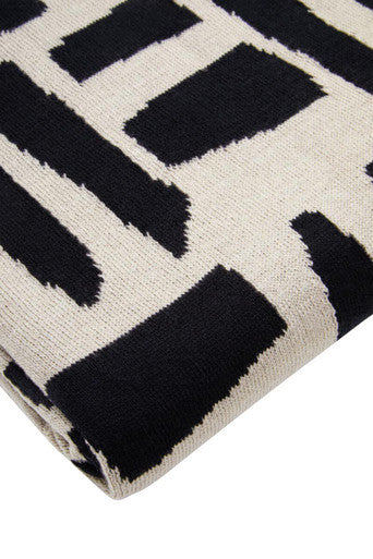 Orsina Black Throw featuring a modern abstract pattern in cream and black for stylish home decor