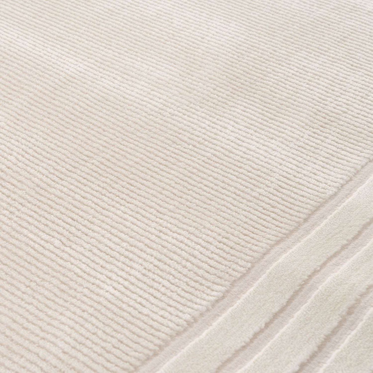 Elegant Bordered Rug in soft cream colour, perfect for adding warmth and style to any room