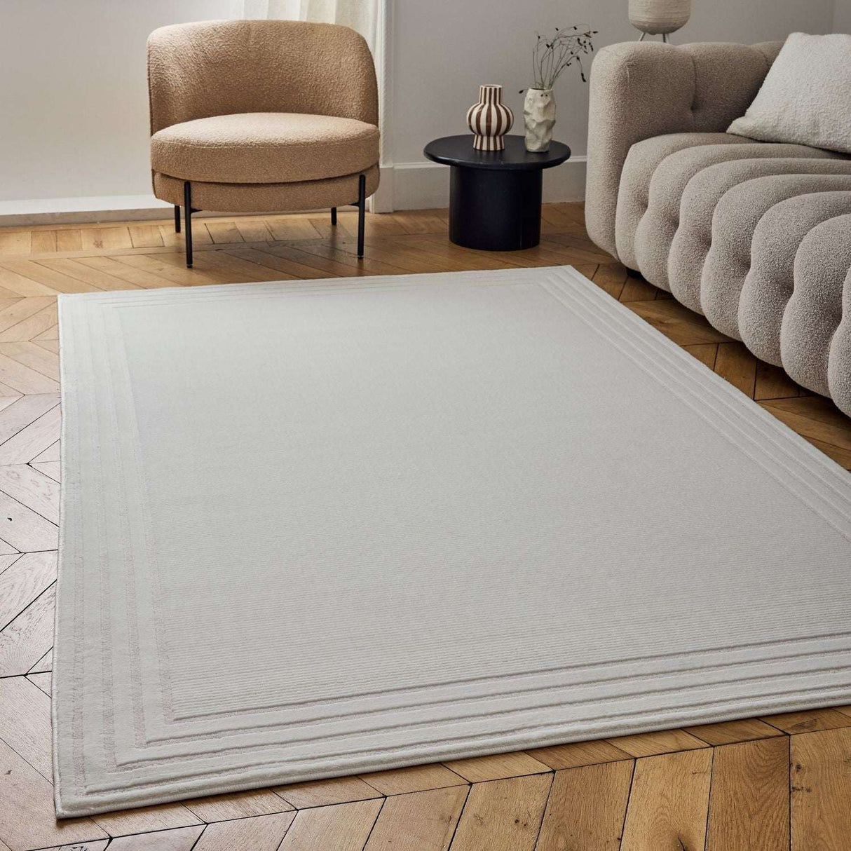 Elegant Bordered Rug in Soft Neutral Tone on Wooden Floor in Contemporary Living Room