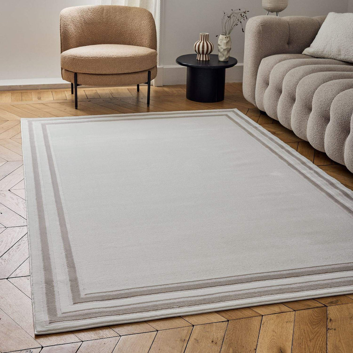 Stylish Bordered Rug in neutral tones, enhancing a modern living room with soft furnishings