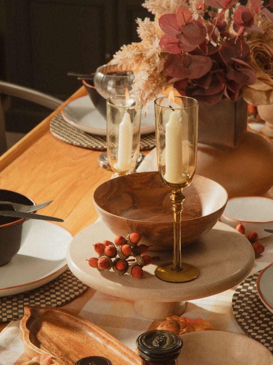 Elegant Orsina Cake Stand on a table setting with decorative elements and candles