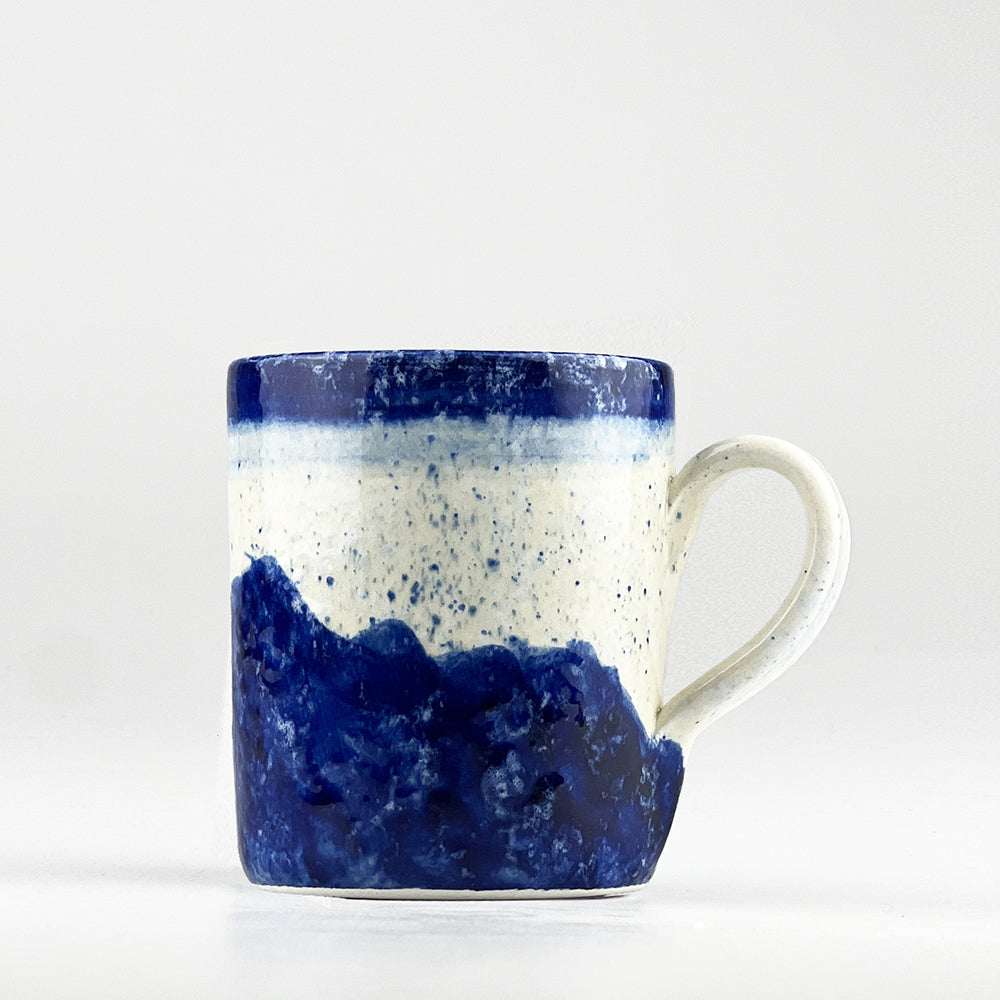 Handcrafted Selbrae House Ceramic Mug in navy blue and speckled white, perfect for enjoying hot beverages