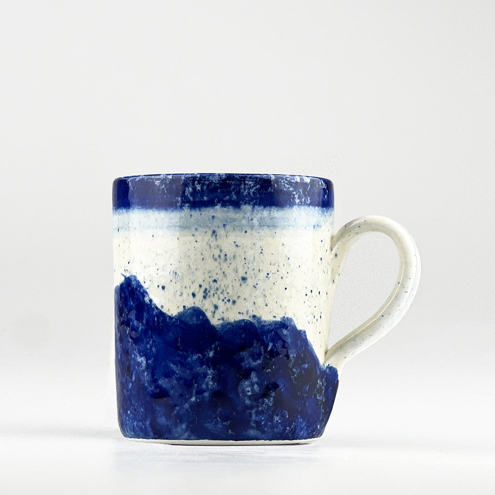 Handcrafted Selbrae House Ceramic Mug in navy blue and speckled white, perfect for enjoying hot beverages