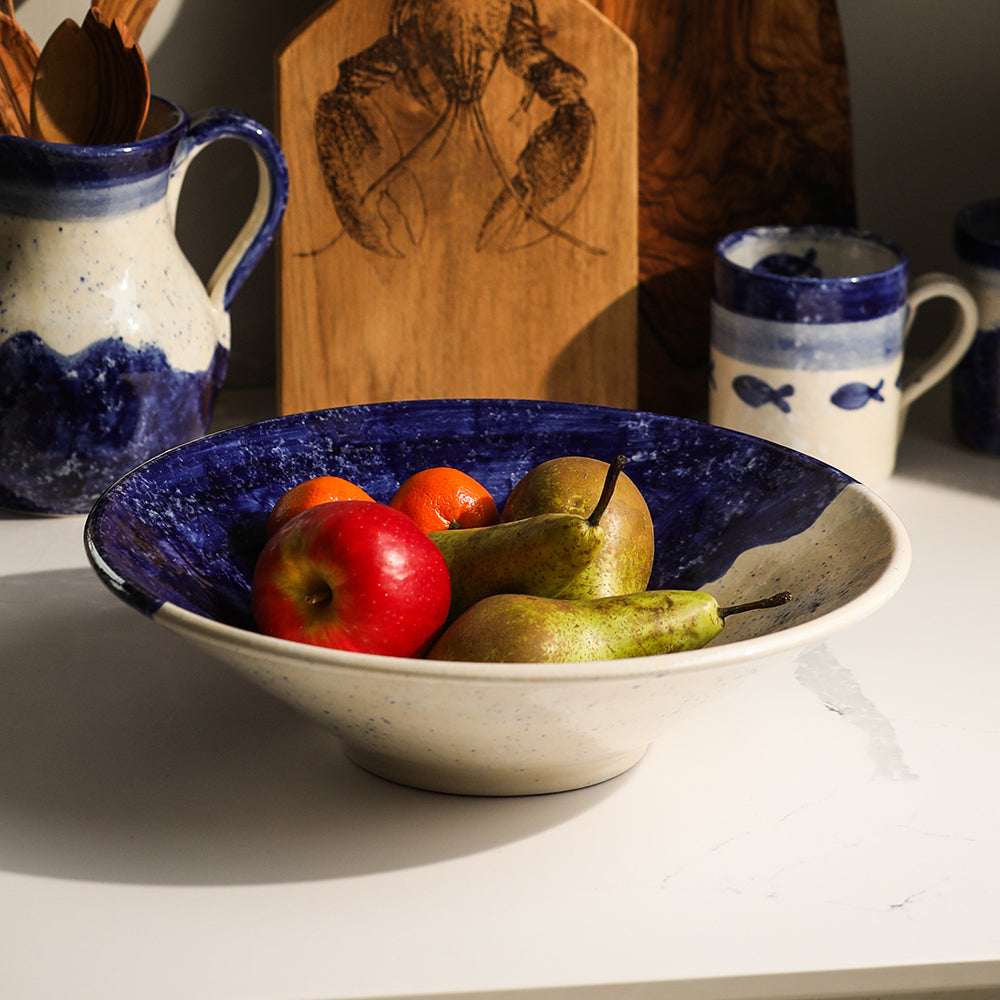 Handcrafted Selbrae House ceramic serving bowl filled with apples and pears on a kitchen countertop