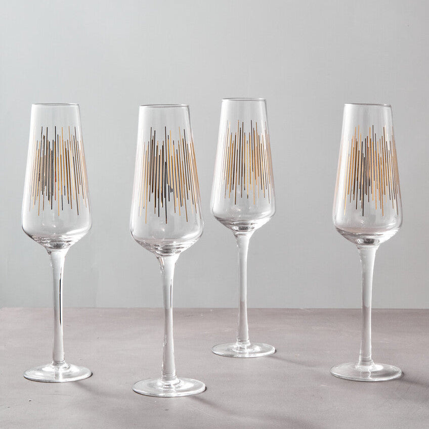 Set of four elegant Orsina Champagne Glasses with modern gold geometric patterns for celebrations