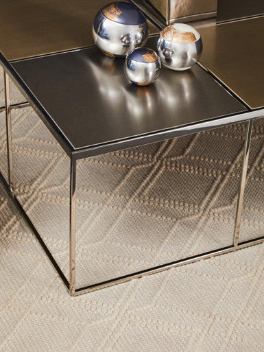 Orsina Coffee Table with a sleek mirrored surface and decorative silver spheres on top