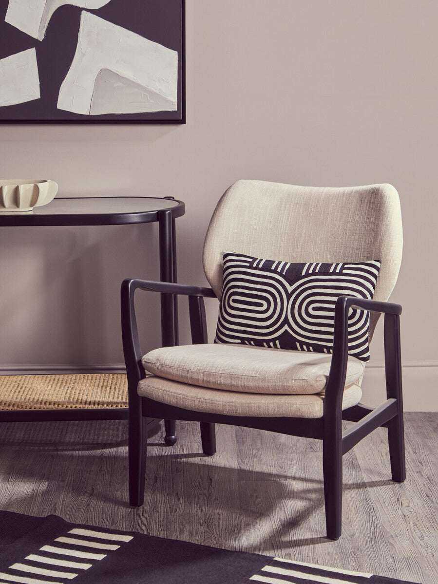 Stylish Orsina Console Table paired with a modern armchair and decorative cushion