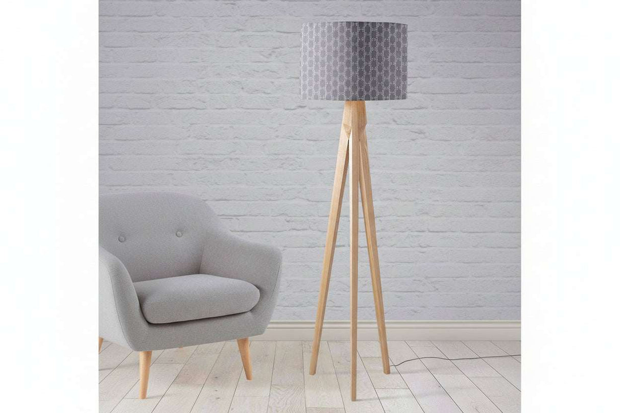 Shadow Bright intricate grey lampshade on a stylish wooden floor lamp in a modern living room