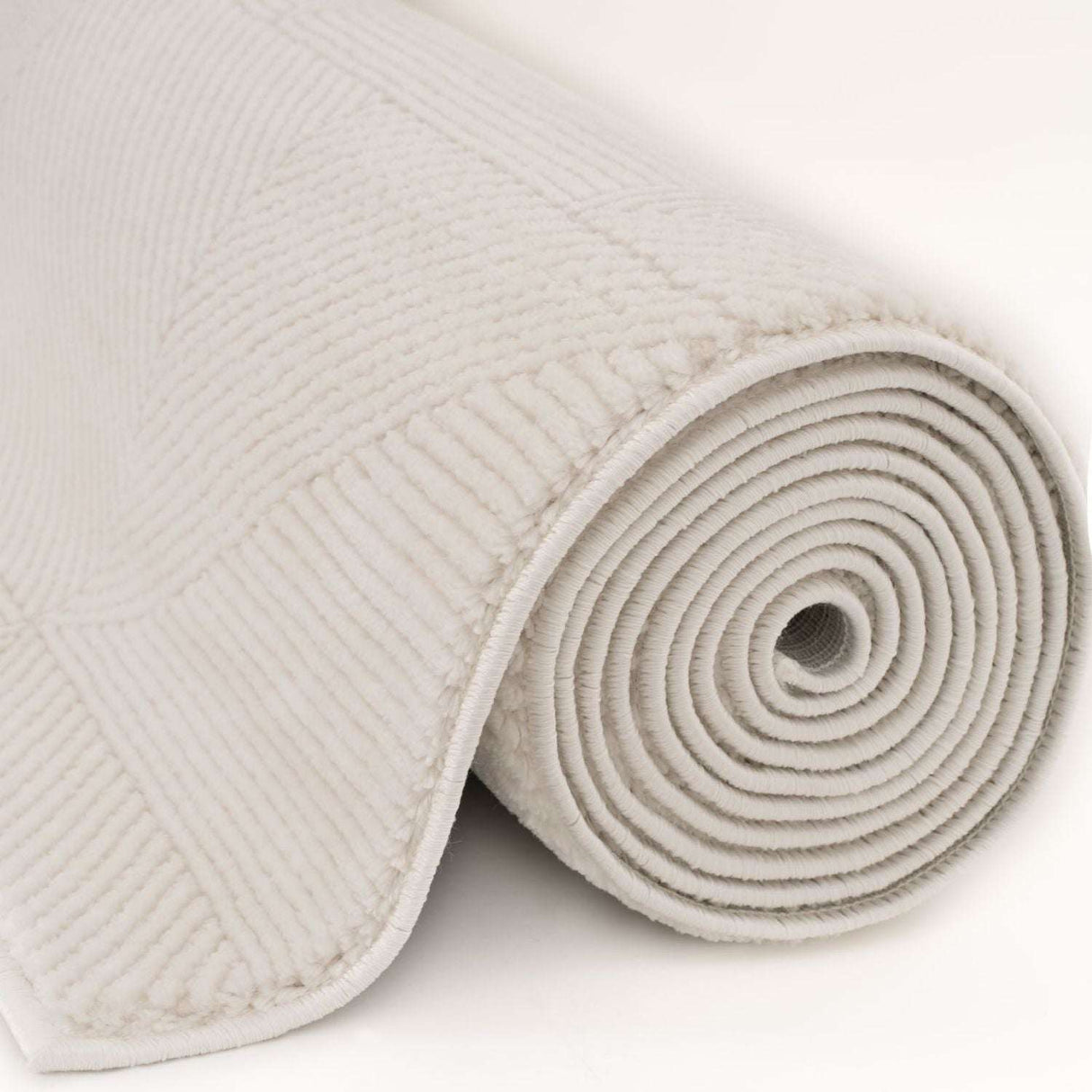 Soft and textured cream rug rolled up, ideal for adding warmth to any room