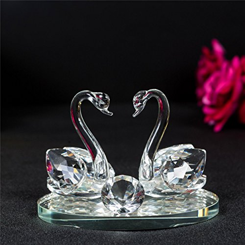 Elegant crystal glass swans figurine on a reflective base, perfect for home decoration