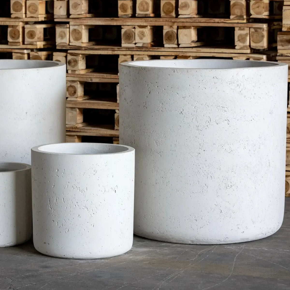 Set of white Jobu Home cylinder planters in various sizes for indoor and outdoor use