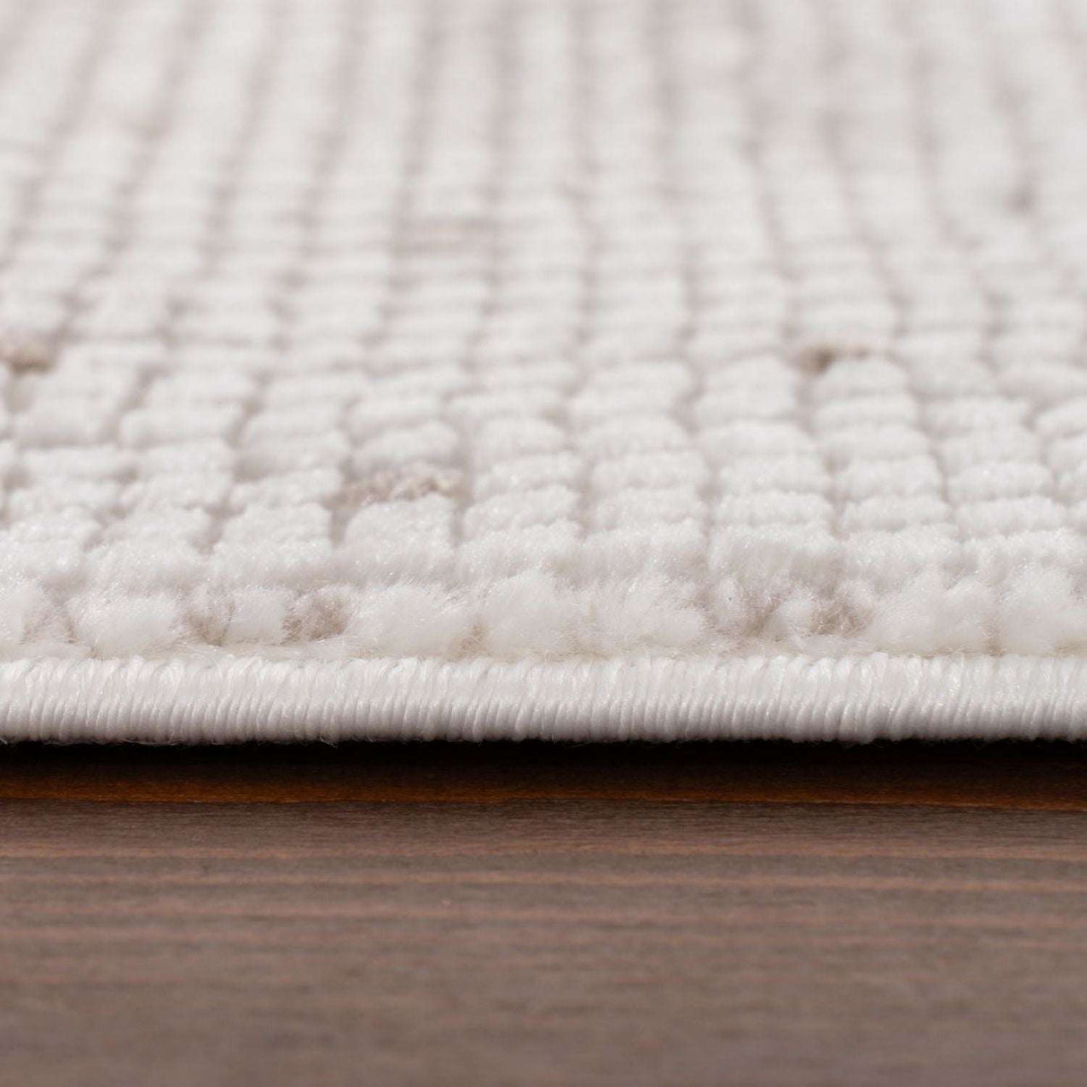 Close-up of a soft Dots Rug in cream colour, showcasing its plush texture and design