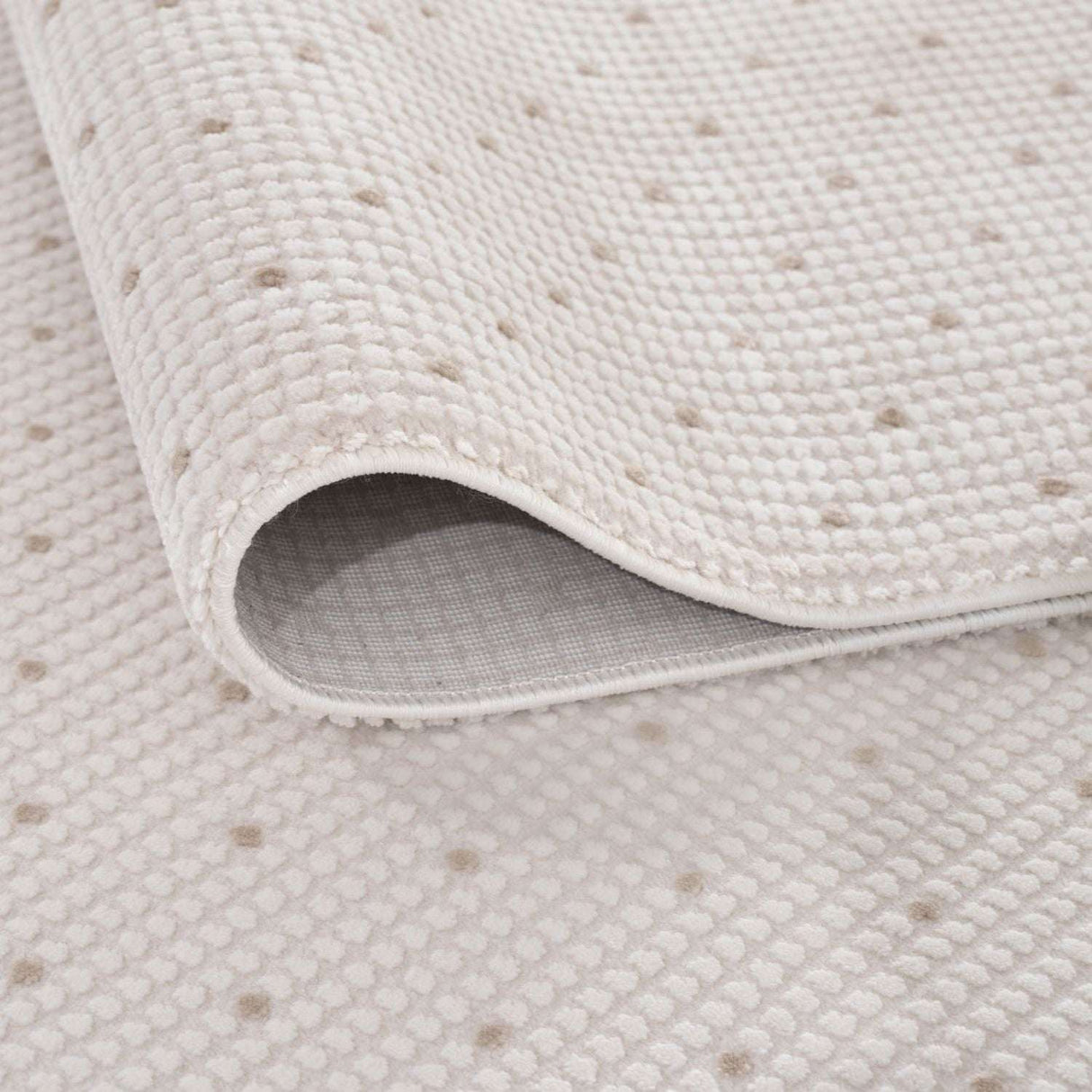 Close-up of a soft Dots Rug with a textured surface in neutral tones, ideal for any home decor