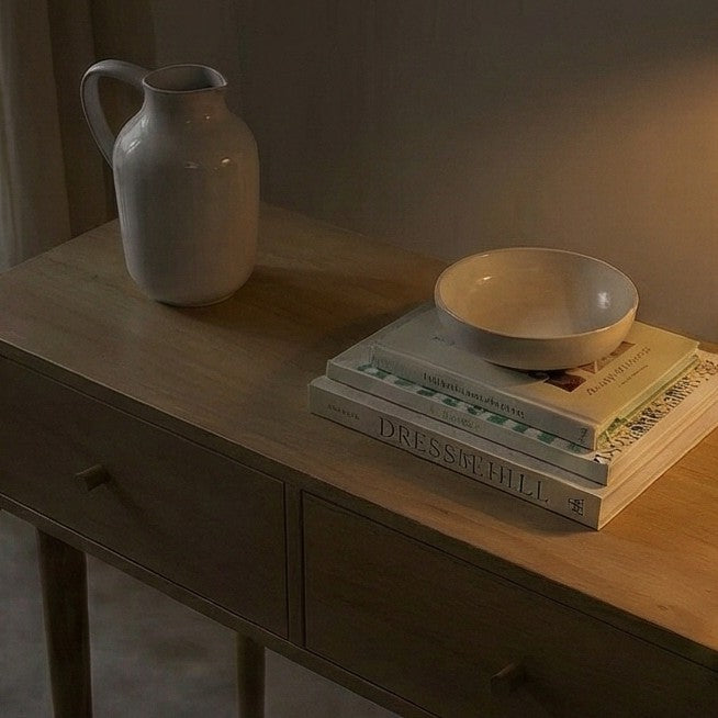 Fishe and Lilly Dressing Table with natural wood finish, books, and decorative items on top