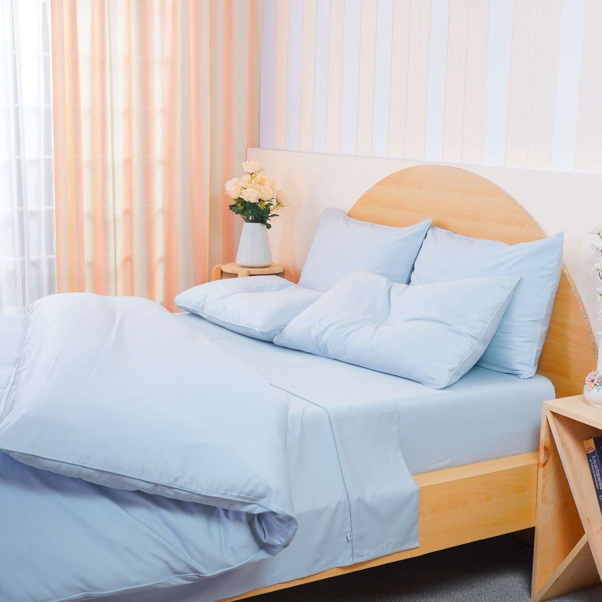 SHEET STORY Duvet Cover Set in soft blue hue on a stylish wooden bed with fluffy pillows