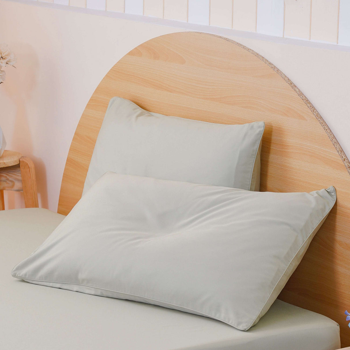SHEET STORY Duvet Cover Set in soft pastel green with two matching pillows on a wooden bed frame