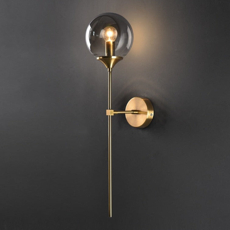 Elegant Light My House Wall Light with a glass globe and brass finish for modern interiors