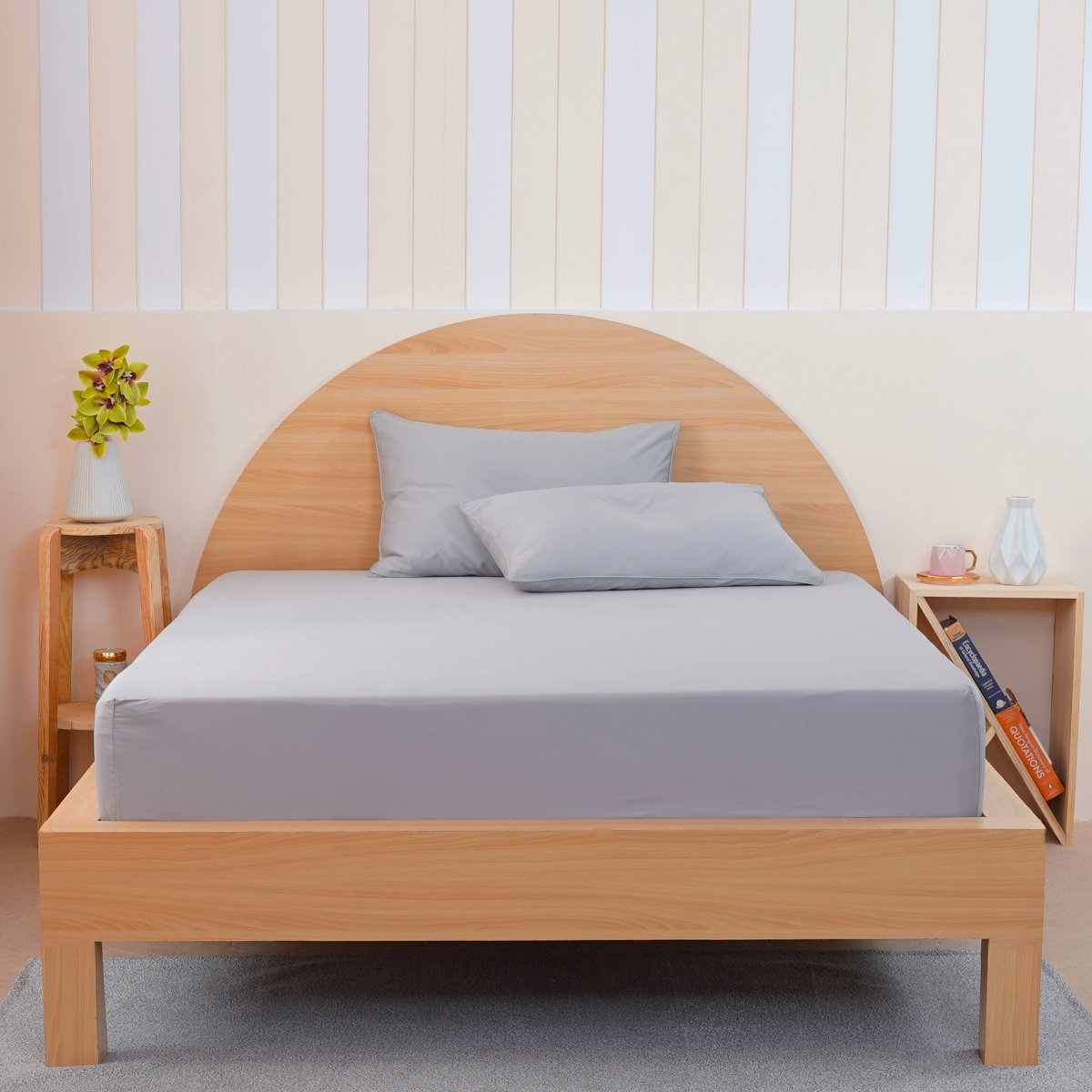 Grey fitted sheet by SHEET STORY on a wooden bed with matching pillows for a modern look