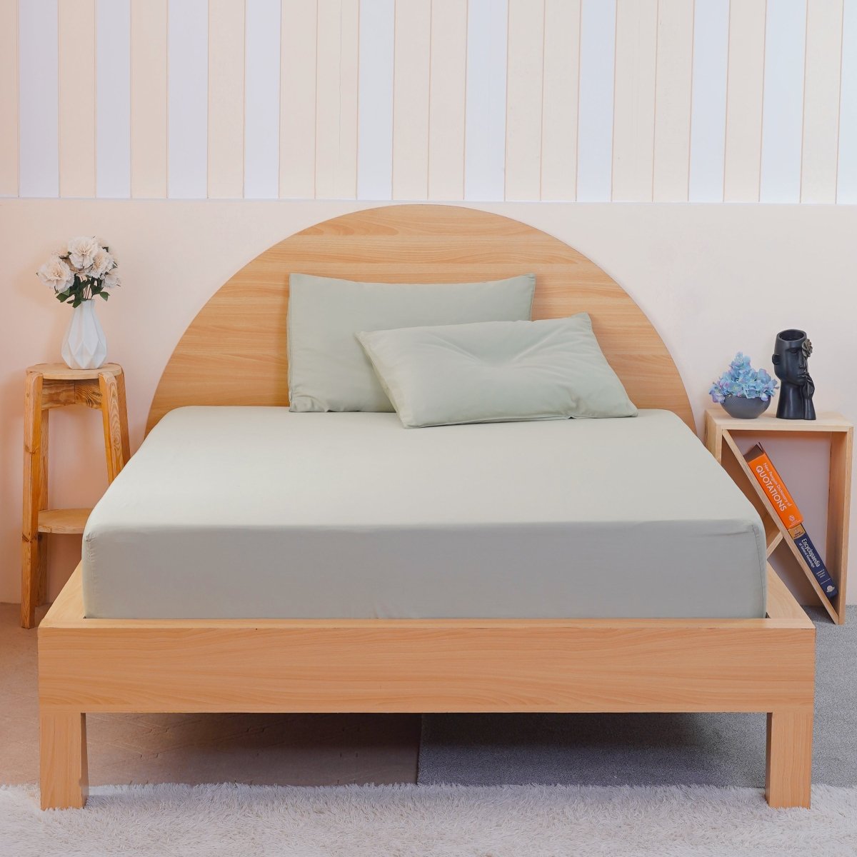 Light green fitted sheet by SHEET STORY on a modern wooden bed with pillows