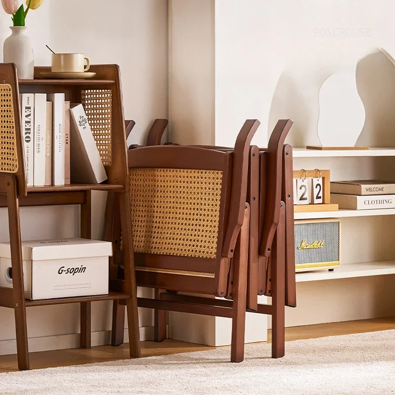 Stylish Nisu Home Folding Chair with a wooden frame and woven rattan backrest, perfect for compact spaces