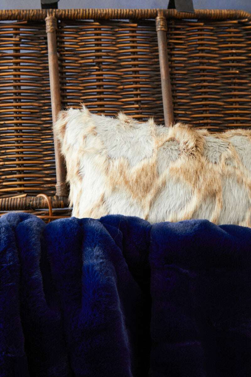 Orsina Fur Cushion in Soft Textures Resting on Blue Faux Fur Blanket for Stylish Home Decor