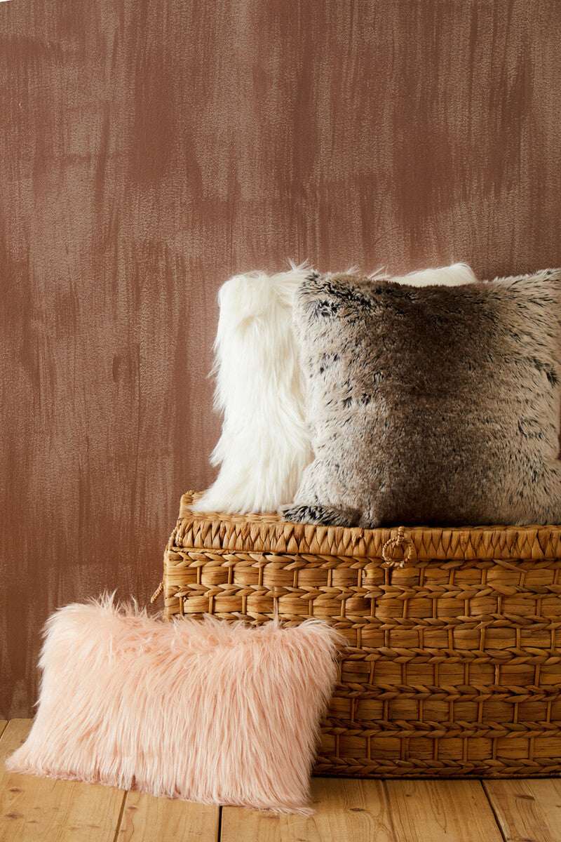 Orsina Fur Cushion collection in various colours displayed on a woven basket for stylish home decor