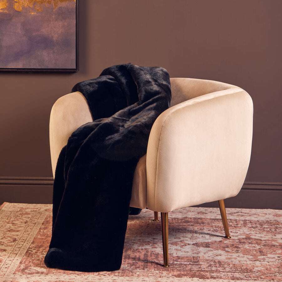 Orsina Luxurious Black Fur Throw Draped Over a Stylish Armchair for Cozy Elegance