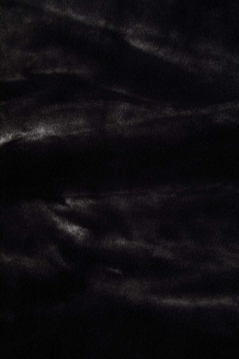 Luxurious black Orsina fur throw featuring a soft, plush texture for warmth and comfort