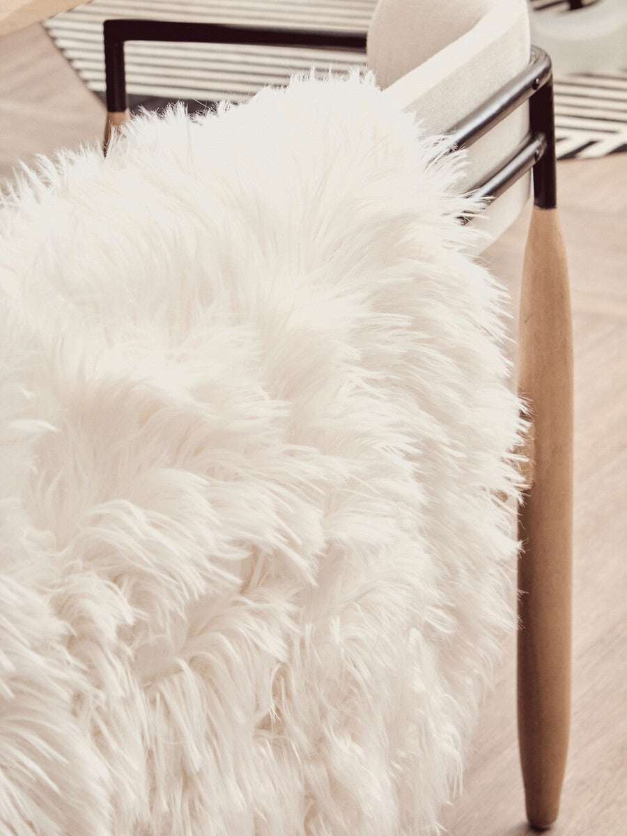Orsina Soft White Fur Throw Draped Over a Modern Chair for Cozy Home Decor