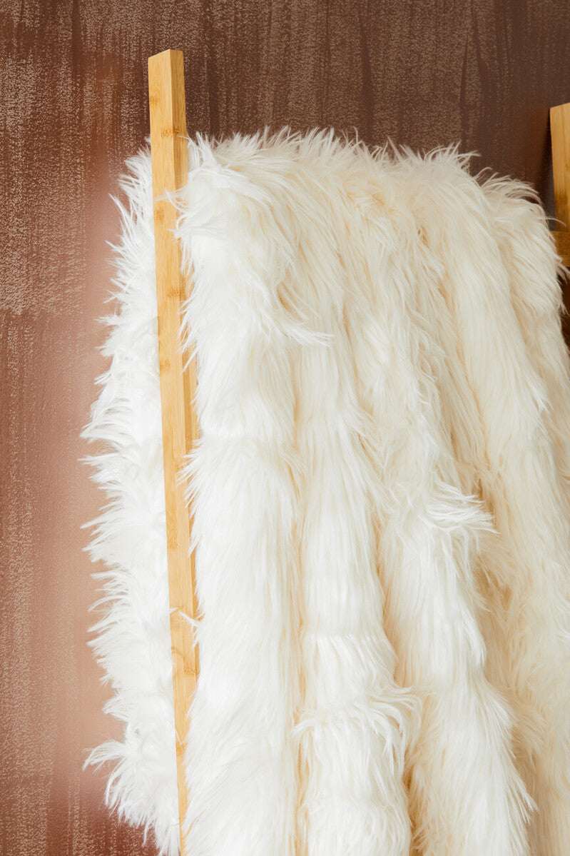 Orsina Soft White Fur Throw Draped on a Wooden Rack for Cozy Decor