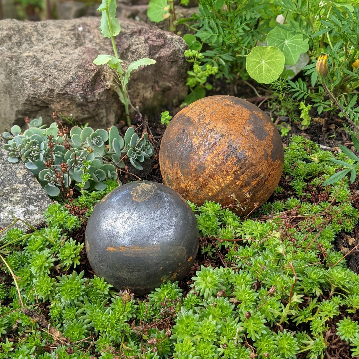 Rustic Garden Metal Balls in a Lush Greenery Setting for Decorative Outdoor Spaces