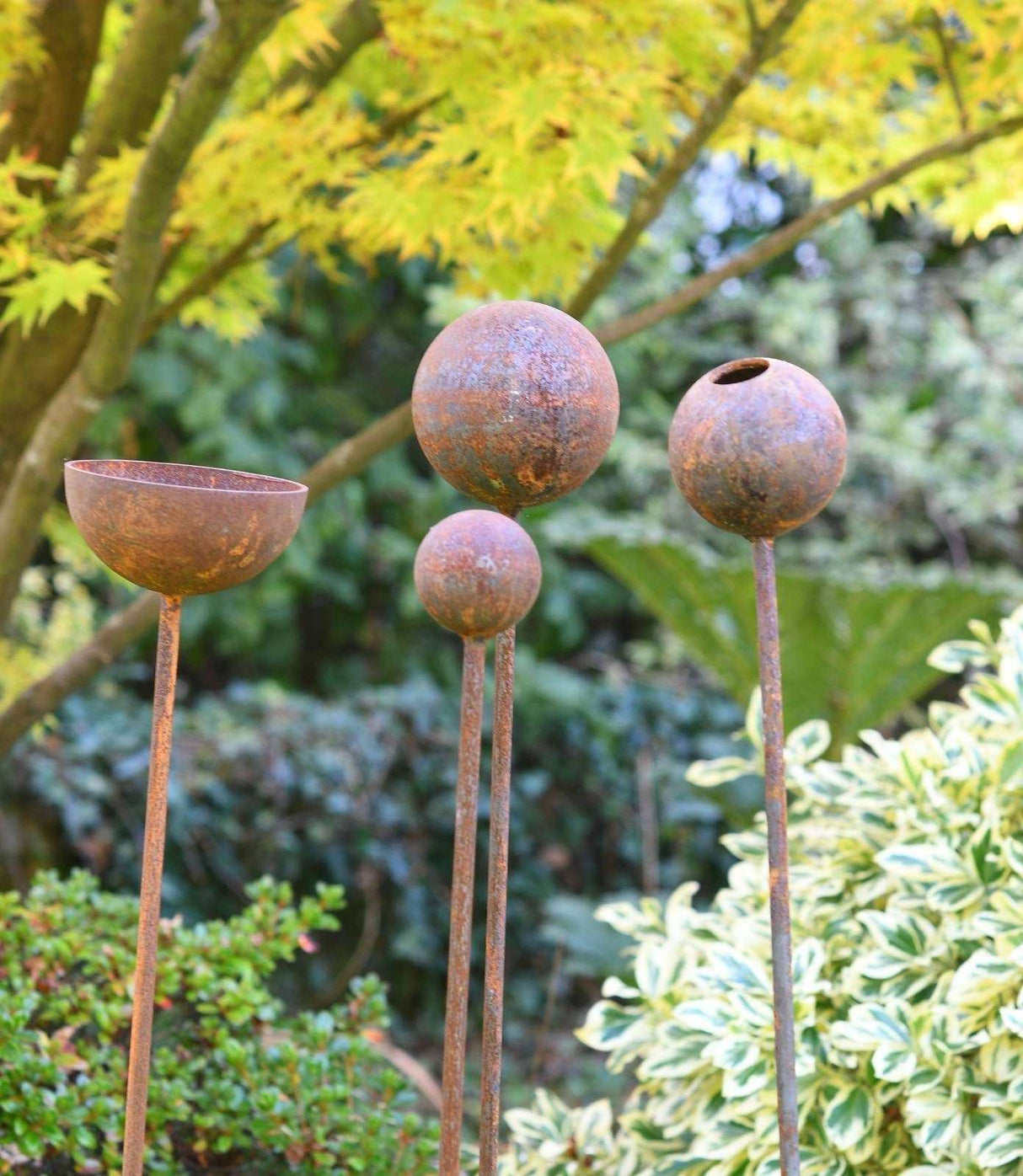 Rustic Garden Sculpture Bundle featuring four unique designs in a natural setting