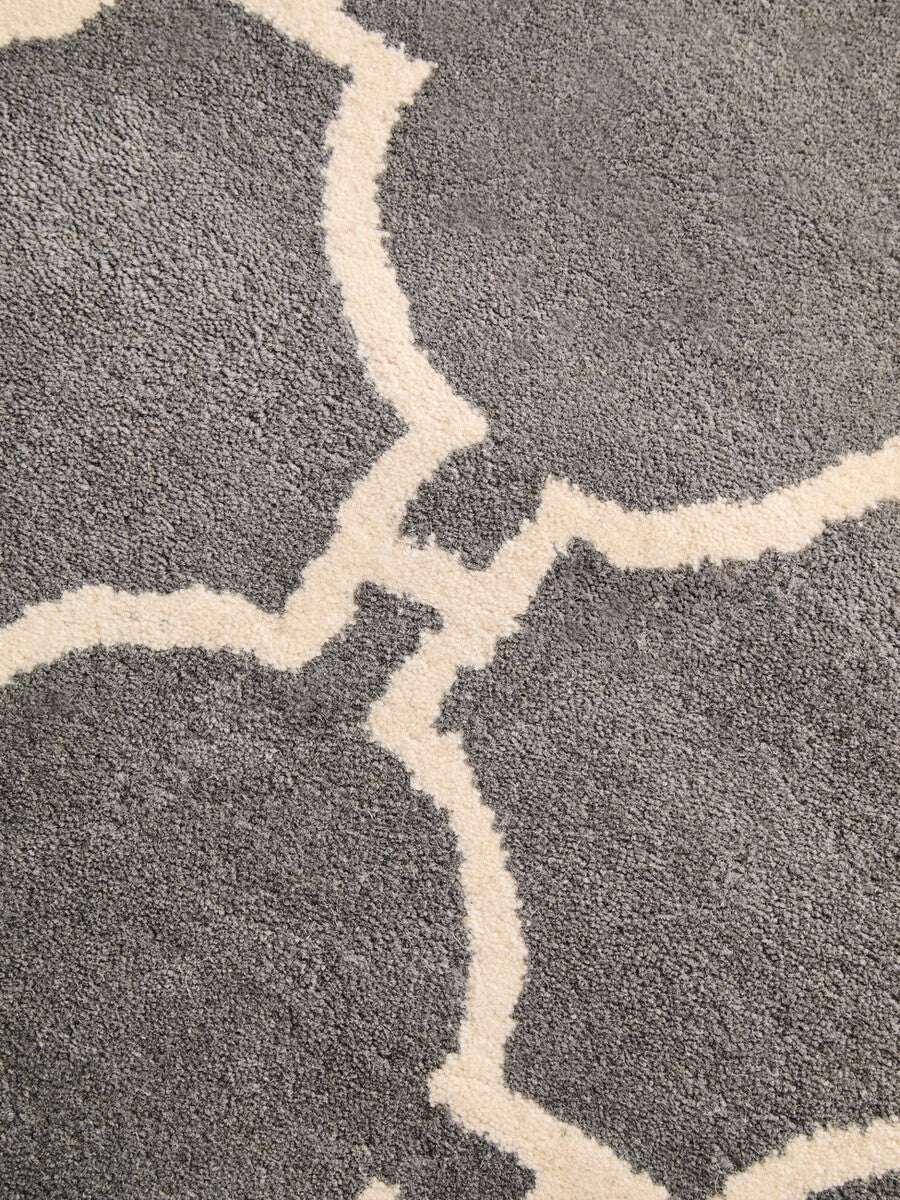 Orsina Hand Woven Rug featuring a grey background with a decorative cream pattern