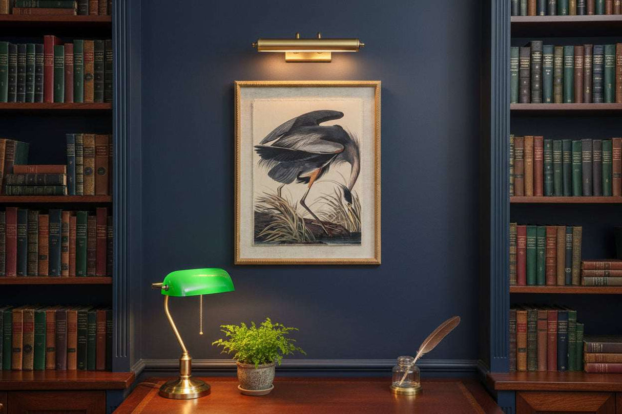 Heron On Linen Artwork elegantly framed in a library with books, table lamp, and desk decor