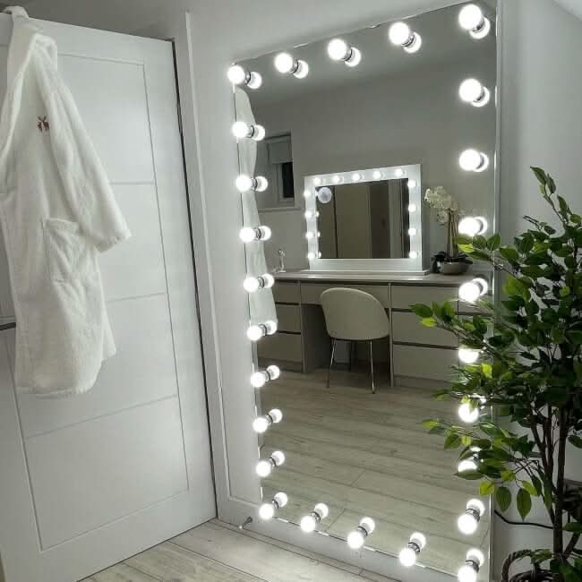 Elegant Hollywood Mirror with bright bulbs, perfect for dressing rooms and stylish interiors