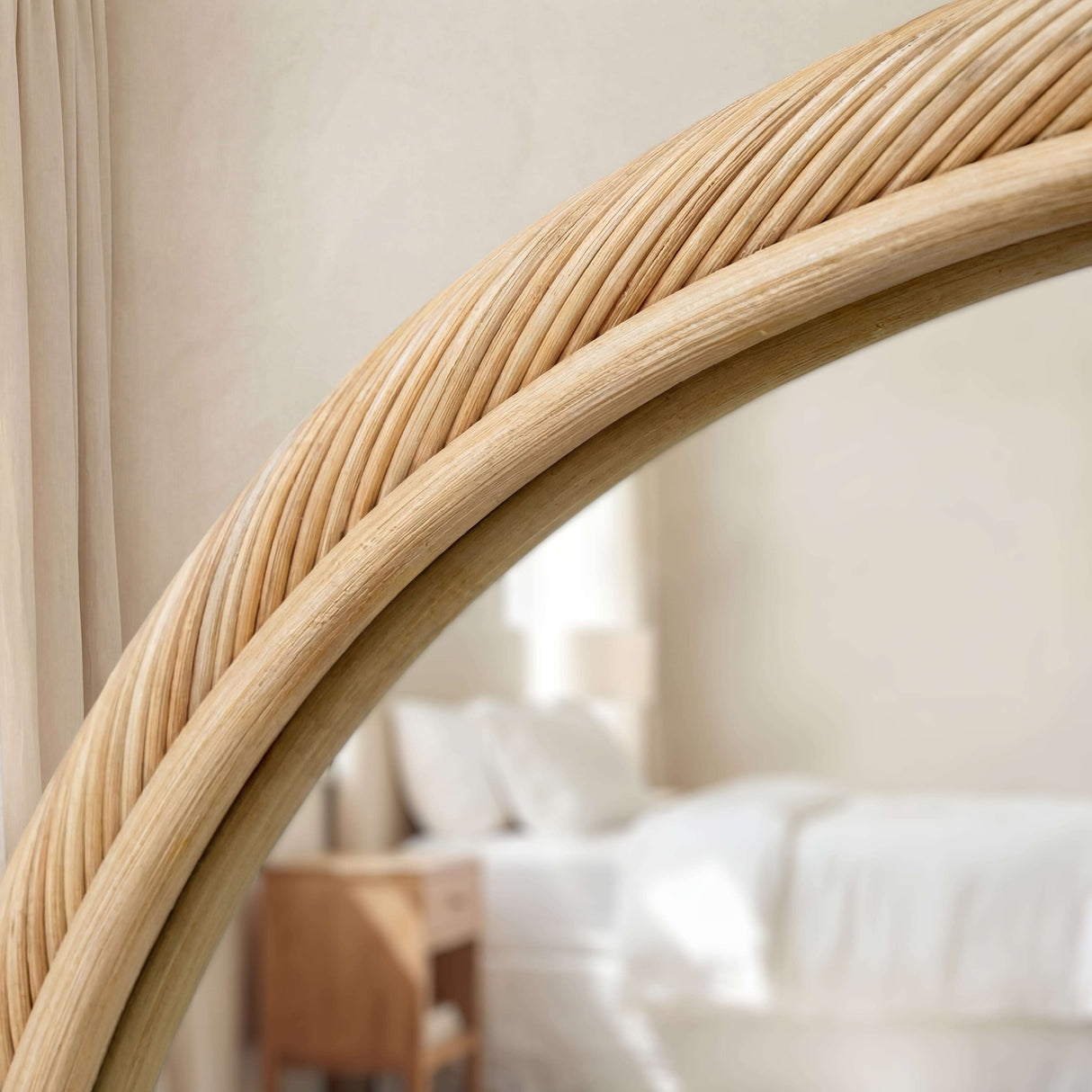 Natural woven rattan frame mirror with a warm finish, ideal for stylish interior decor