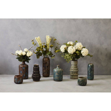 Orsina ceramic planters in various shapes and sizes, beautifully arranged with floral arrangements