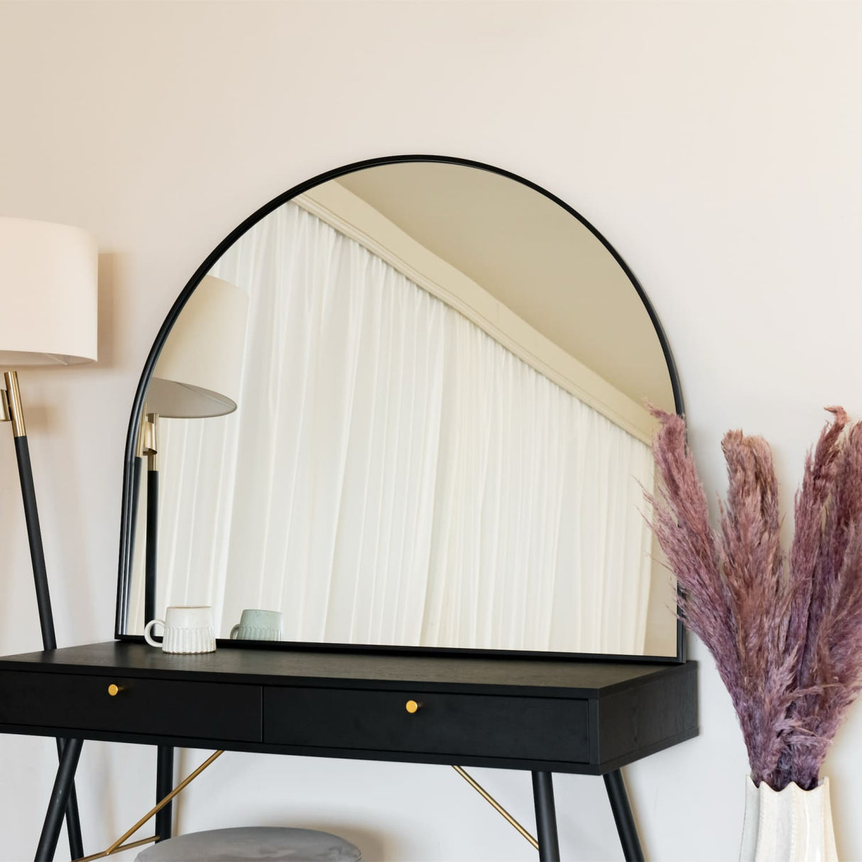 Stylish Jobu Home Arched Mirror above a black vanity table with elegant decor