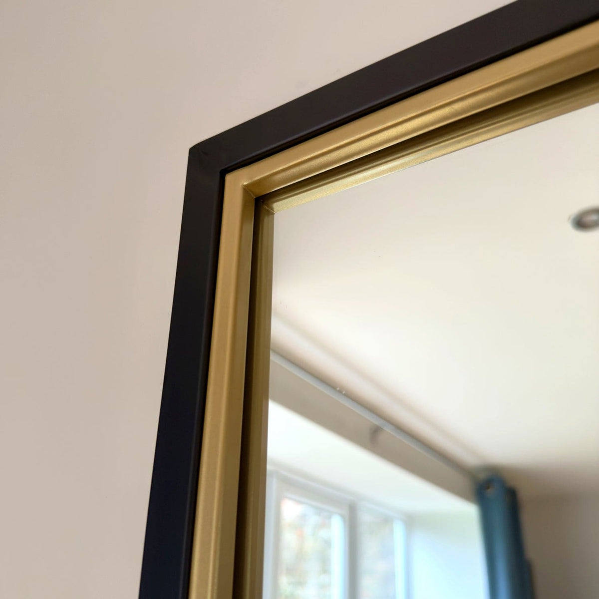 Elegant Jobu Home Grid Mirror with a black and gold frame, perfect for modern interiors